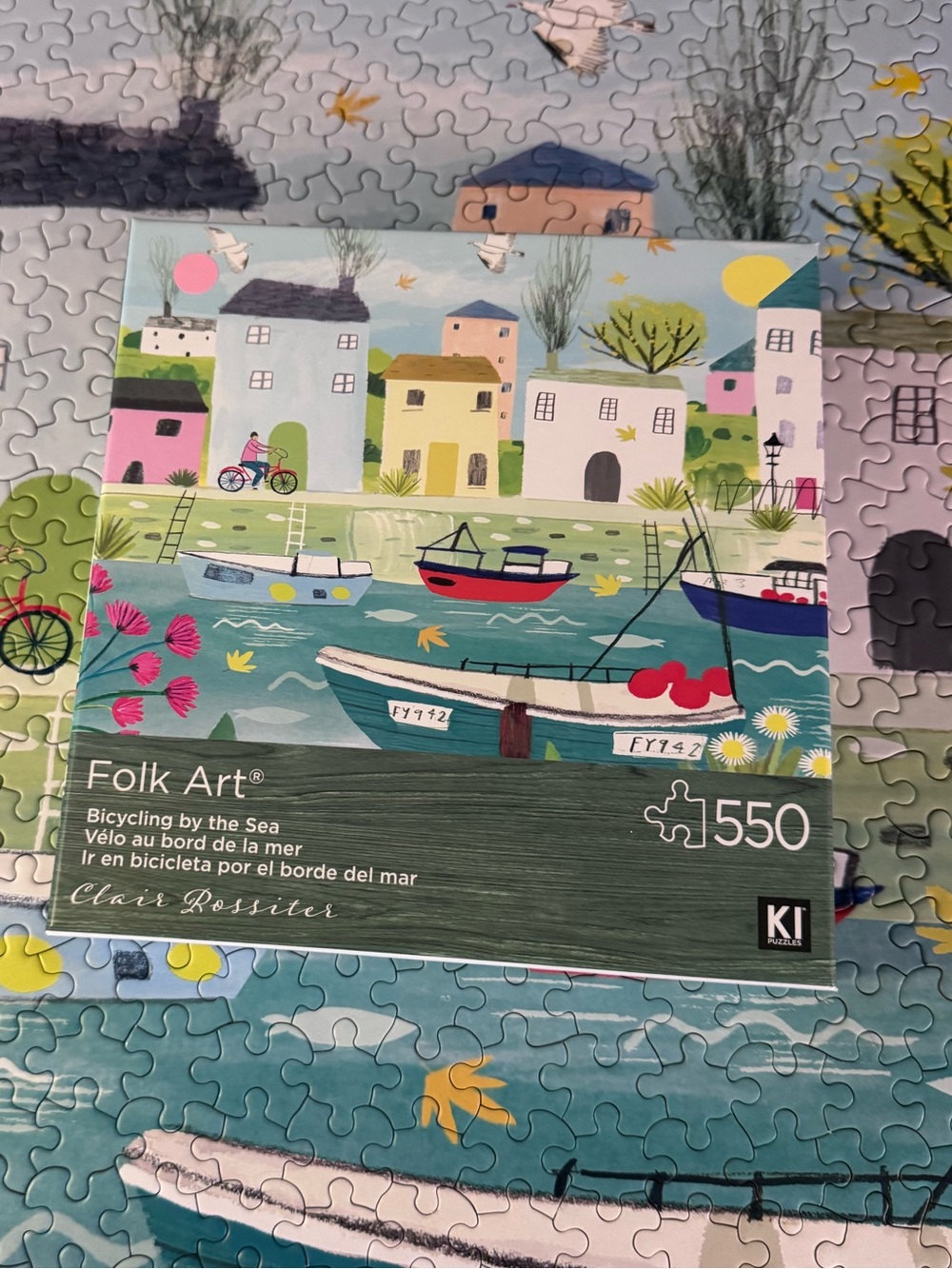 KI puzzles Folk Art Bicycling by the sea Coastal Village Boat 550 piece Puzzle